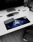 28x12 inches anime girl mouse pad showing a cool blonde heroine in a flowing cloak amid blue swirls.