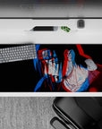 Dark anime desk pad 36x16 inches in moody black with trippy red/blue genjutsu-style shift.