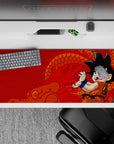 Sleek 36x16 inch desk pad featuring Kid Goku and bold red design, ideal for classic anime lovers