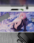 Winter dreamscape 40x20 desk pad with Zero Two in a serene snowy setting, where soft purples and a golden sunset create a mesmerizing contrast