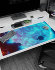 Space scene desk pad featuring an icy-blue moon with floating rocks and cloud bands, 40x20 inches.
