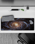 Galaxy themed desk mouse pad with smooth surface and cosmic swirl design, size 32x12 inches.