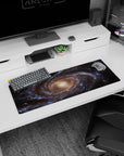 Large 32x12 inch mouse pad featuring a spiral galaxy design with blue tones, golden core, and cosmic details.