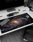 Large 40x20 inch desk pad with a dreamy spiral galaxy design featuring blue, gold, and deep space tones.