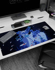 Anime girl close-up desk pad 40x20 inches, gentle gaze framed by blue flowers and drifting koi confetti.
