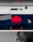 36x16 inches desk pad with the Midnight Skyline Eclipse, capturing the bold contrast of a sleek car and a red moon against a dark night sky.