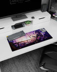 Silver-haired anime girl with katana pose on mouse pad 28x12 inches, glowing city backdrop and petals.