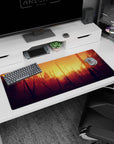 Artistic 36x16 inches mouse pad with a sunset forest, featuring warm oranges and golds for a creative and inspiring workspace.
