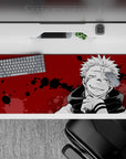 Chilling 36x16 desk pad featuring Sukuna's cursed spirit aura with eerie ink splatters from Jujutsu Kaisen
