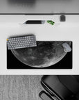 Deep black space mouse pad 28x12 inches with dusty gray craters and soft silver glow, calm night vibe.