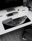 Giant cratered moon drifting above speckled stars 32x12 inches extended mouse pad for desk setup.
