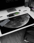 Giant cratered moon over speckled stars desk pad 40x20 inches, like a calm late-night sky.