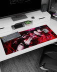 Raven-haired anime heroine amid red sparks on desk pad 36x16 inches, glowing amber eyes in crimson leather.