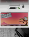 Dynamic 32x16 desk mat combines serene mountain, tree, and sunset tones for impactful yet soothing visuals