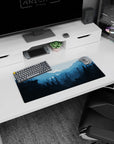 Serene 28x12 mouse pad with layered blue peaks and a glowing moon for a peaceful workspace atmosphere