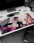 Large 40x20 inches desk pad featuring Jeanne d'Arc Alter, symbolizing vengeance and power with a black flag and pink petals swirling around her.