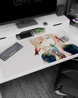 Anime girl with watery blue eyes holding a teal jewel to her lips on a 40x20 inches desk pad.