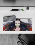 Nezuko anime mouse pad, 28x12 inches, features her serene gaze, flowing black hair with red tips, and gold flecks on white.
