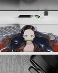 Nezuko anime mouse pad, 36x16 inches, featuring Nezuko's serene gaze, black hair with red tips, and gold flecks on white.