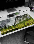 Large 40x20 inches mouse pad featuring serene nature design, with towering pines, misty mountain peaks, and calm water reflections.