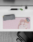 28x12 inches blush-pink kawaii anime desk mat, soft romantic vibe with candy-cloud doodles and cozy couple.