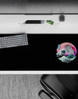Striking 36x16 desk pad highlights geometric mountains and crashing wave under vibrant neon sunset tones