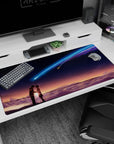 Two students lean close beneath a neon blue comet on an indigo sky anime desk pad 40x20 inches.