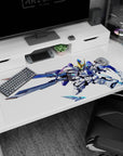 Chibi mecha with sharp gold V-fin and huge swords on anime desk pad 40x20 inches.