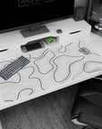 Large 40x20 inches desk pad featuring black and white contour design, adding depth and movement with bold black lines over a white background.