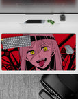 Chaotic 32x16 mouse pad featuring Nayuta with glowing eyes, sharp fangs, and a crimson battlefield for an unhinged, villainous workspace vibe