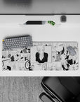 Black-and-white desk mat with blonde anime girl and deep V black top, 32x12 inches, cheeky vibe.