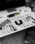 Blonde anime girl smirking in a deep V black top on manga panel desk pad 40x20 inches.