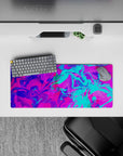 Bold 28x12 mouse pad with swirling neon pink, electric blue, and purple tones, perfect for a creative and energetic workspace
