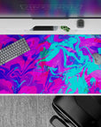 Bold 40x20 desk pad with swirling neon pink, electric blue, and vivid purple tones, bringing excitement and creativity to your desk