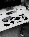 Modern 32x12 mouse pad with bold black and white cow print spots, perfect for adding personality and playfulness to your desk