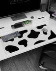 Modern 36x16 anime desk mat featuring bold black and white cow print spots, adding personality and playfulness to your desk setup