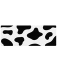 Cow print 32x12 mouse pad with bold black and white spots, bringing a fun, playful vibe to your desk