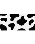 Cow print 36x16 desk pad featuring black and white spots for a playful, modern design that adds a whimsical touch to your desk