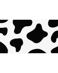 Cow print 40x20 desk pad with bold black and white spots, adding a playful and modern touch to your workspace