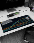 Futuristic 36x16 anime desk mat with dynamic curves in teal, yellow, and red, creating a tech-inspired, organized aesthetic
