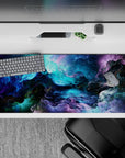 Striking 36x16 desk pad highlights deep blues, purples, and emerald tones with intricate swirling details in stunning artistry