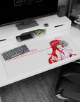 Rias Gremory from High School DxD on a 36x16 inch desk pad, sipping a drink, with crimson hair and a confident smirk.