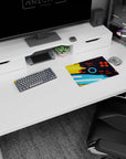 Iconic 14x10 desk mat celebrates Color Splash Energy with yellow, orange, and blue strokes, sharp geometry, and dynamic flair