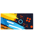 Color Splash Energy Desk Mat 32x16 featuring geometric bursts for gaming or workspace energy with artistic edge