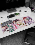 36x16 inches anime girl desk pad with bespectacled heroine, glossy hair and blush, friends behind in pastel skirts.