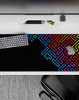 36x16 inches mouse pad with a neon geometric pattern, featuring vivid blue, purple, red, and yellow against a deep black backdrop for modern style.