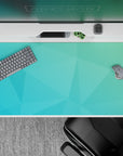Tranquil 40x20 desk pad with soft teal and aqua gradient and overlapping polygons for a refreshing aquatic design
