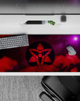 Anime desk pad 36x16 inches in bold reds and cosmic purples, intense mysterious shinobi mood.