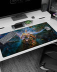 Starry space scene desk pad 40x20 inches featuring teal clouds and a bold golden dust pillar at center.