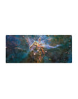 Cosmic nebula desk mouse pad 28x12 inches with teal clouds, inky blues, and starry specks.